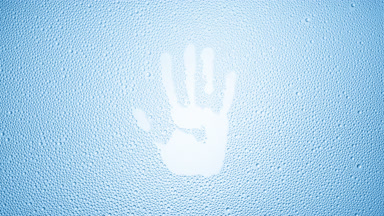 Handprint blown off the wet glass on blue background