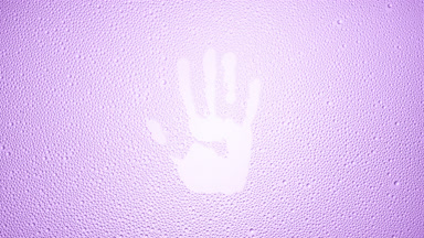 Handprint blown off the wet glass on violet background