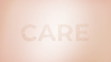 Care word blown off the wet glass on beige background