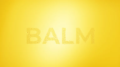 Balm writing blown off the wet glass on yellow background
