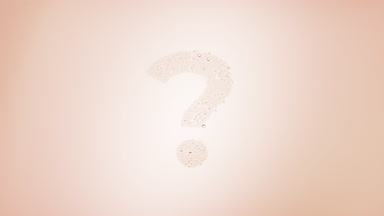 Question mark blown off the wet glass on beige background