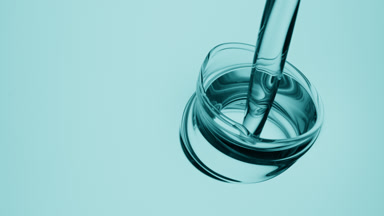 Cyan oil is being poured into cyan oil on cyan background