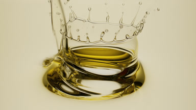 Macro shot of camellia oil is being poured into pale yellow oil