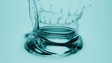 Side view macro shot of cyan oil is being poured into cyan oil