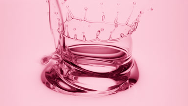 Side view macro shot of rose oil is being poured into rose oil