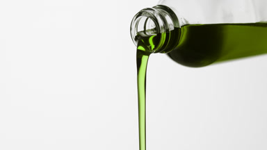 Reagent bottle is being tilted and hemp oil pours from it