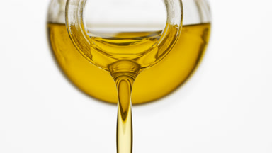 Reagent bottle is being tilted and jojoba oil pours from it