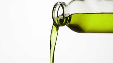 Reagent bottle is being tilted and green fluid pours from it