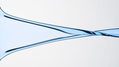 Macro of cyan liquid is flowing and dripping on grey background