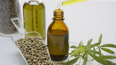 Oil drips in bottle near seed scoop, sprig, seed jar, oil bottle