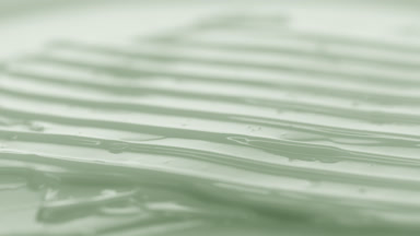 Crane macro of green cream with green tea extract wave texture