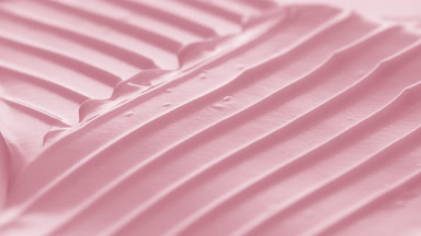 Macro turntable jib shot of pink cosmetic cream
