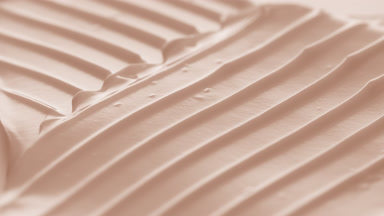 Macro turntable jib shot of beige cosmetic cream