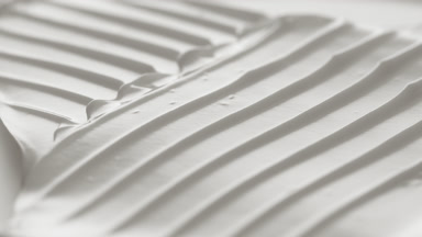 Macro turntable crane shot of white cosmetic cream