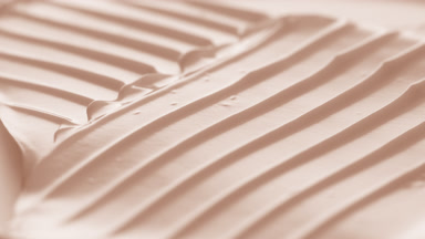 Macro turntable crane shot of beige cosmetic cream