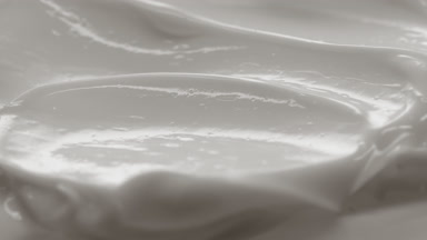 Side view macro turntable white cosmetic cream texture shot