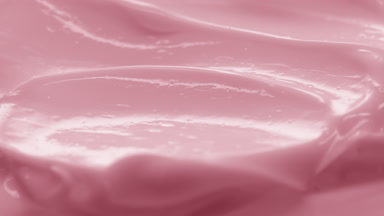 Side view macro turntable pink cosmetic cream texture shot