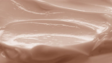 Side view macro turntable beige cosmetic cream texture shot