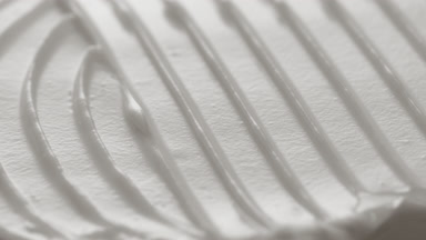 Macro turntable crane shot of white cosmetic cream texture