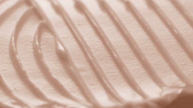 Macro turntable crane shot of beige cosmetic cream texture