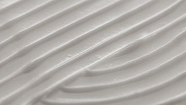 Side view macro turntable shot of white cosmetic cream surface