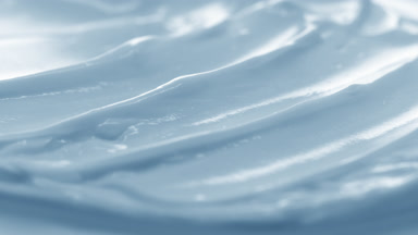 Macro crane shot of blue cosmetic cream surface