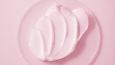 Extreme close-up jib shot of pink cream on watch glass round