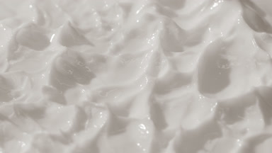 Top view macro shot of white cream with changing lighting