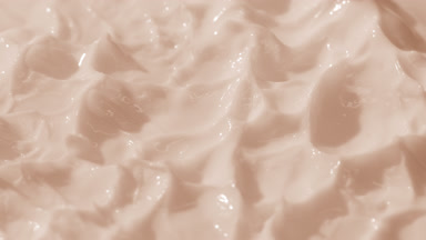 Top view macro shot of pink cream with changing lighting