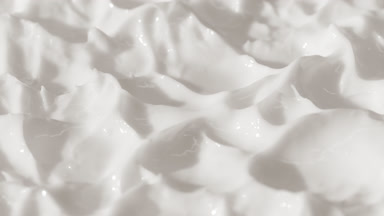 Side view macro turntable shot of white cosmetic cream texture