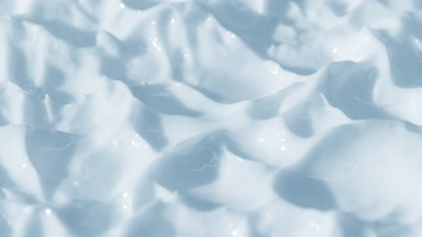 Side view macro turntable shot of blue cosmetic cream texture