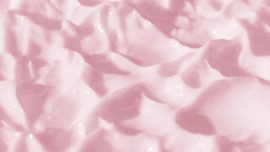 Side view macro turntable shot of pink cosmetic cream texture