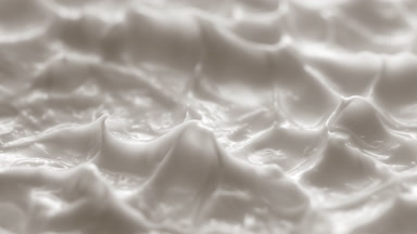 Side view macro turntable shot of white cream texture in shadow