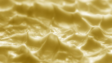 Side view macro turntable shot of yellow cream texture in shadow
