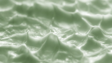 Side view macro turntable shot of green cream texture in shadow