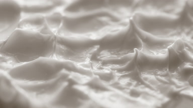 Jib macro turntable shot of white cream texture in shadow