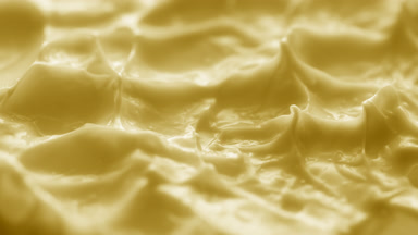 Jib macro turntable shot of yellow cream texture in shadow