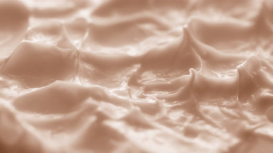 Jib macro turntable shot of beige cream texture in shadow