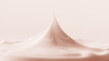 Macro shot of beige cap has been removed from the beige cream