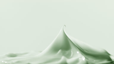 Macro turntable shot of green cosmetic cream jar has been opened