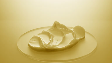 Extreme close-up crane shot of yellow night cream on watch glass
