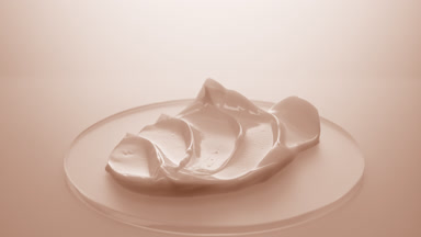 Extreme close-up crane shot of beige night cream on watch glass