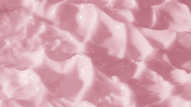 Side view macro turntable shot of pink day cream surface