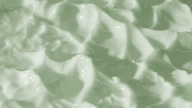 Side view macro turntable shot of green day cream surface