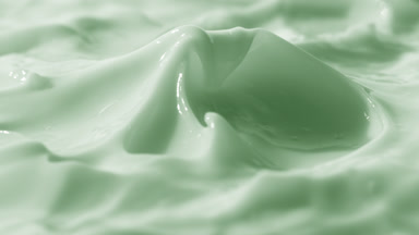Side view turntable shot of green cream surface with peak