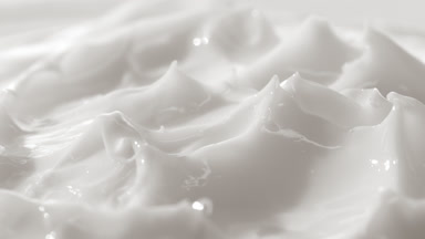 Macro crane turntable shot of white skin care cream surface