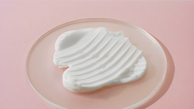Crane shot of white day cream on watch glass on pink background