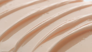 Macro texture of beige night cream with sandalwood powder