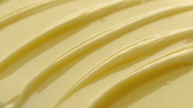 Jib macro texture of yellow nourishing cream with collagen