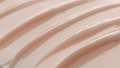 Macro of beige nourishing cream with carrot oil and shea butter
